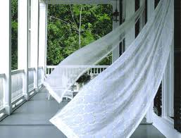 curtains waving in the breeze on a porch